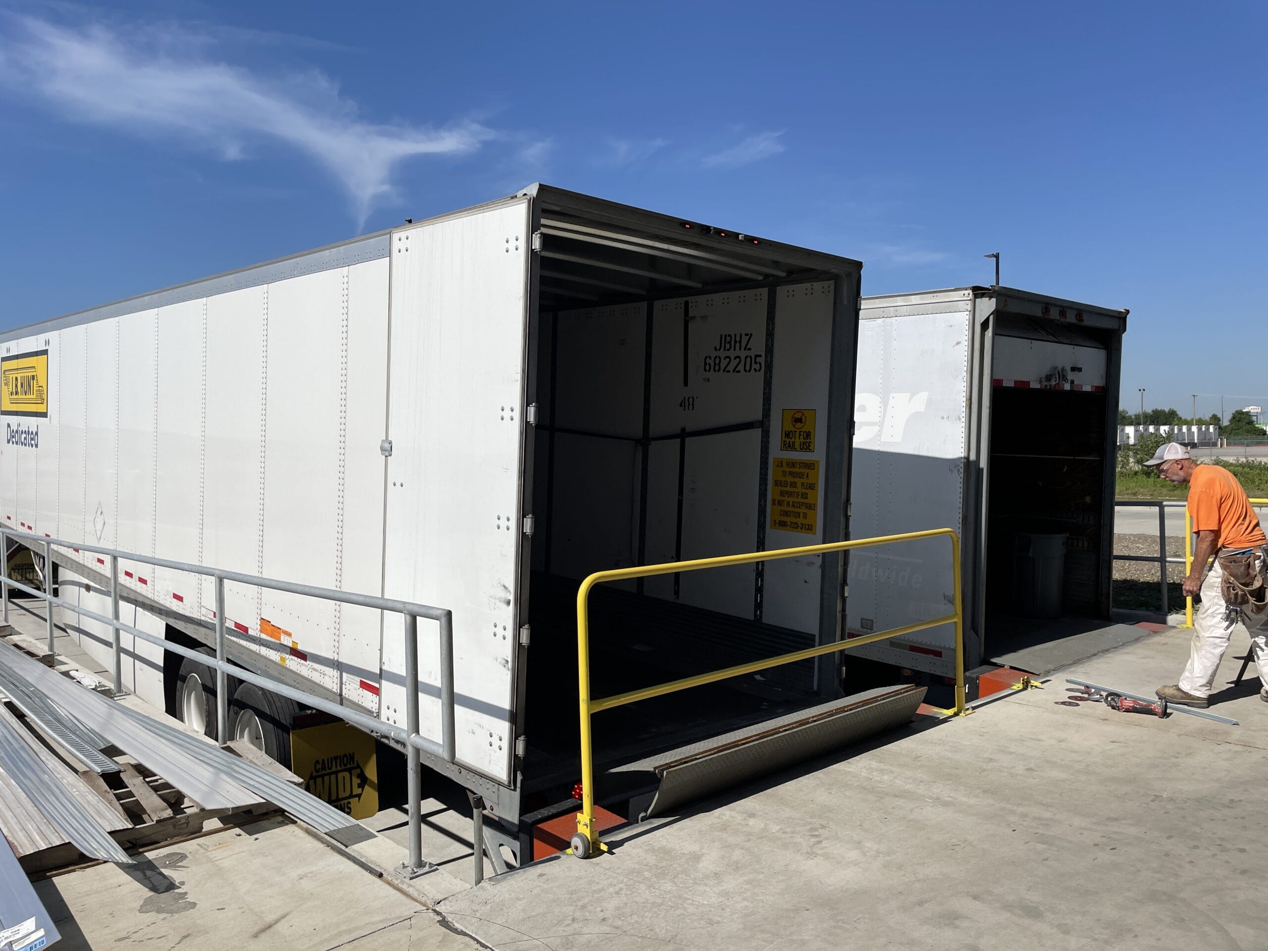 Two dry van trailers pulled into the transloading dock at River-Roads